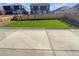 A beautifully manicured backyard featuring artificial turf, a concrete patio, and a privacy fence at 20028 E 62Nd Ave, Aurora, CO 80019