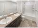 Clean bathroom with double sink vanity, tile floors, and shower/tub combination at 20028 E 62Nd Ave, Aurora, CO 80019