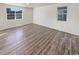 Bright room featuring vinyl floors, natural light, and neutral paint at 20028 E 62Nd Ave, Aurora, CO 80019