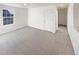 Well-lit bedroom with neutral carpet, a window, and a conveniently placed door at 20028 E 62Nd Ave, Aurora, CO 80019