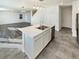 A modern kitchen island features stainless steel sink, and stylish pendant lighting at 20028 E 62Nd Ave, Aurora, CO 80019