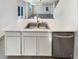 Modern kitchen island with stainless steel sink, dishwasher and white cabinets at 20028 E 62Nd Ave, Aurora, CO 80019