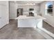 Modern kitchen with white cabinetry, stainless steel appliances, and a kitchen island at 20028 E 62Nd Ave, Aurora, CO 80019