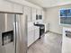 Bright kitchen with stainless steel appliances, white cabinets, and modern countertops at 20028 E 62Nd Ave, Aurora, CO 80019