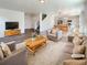 Bright living room featuring hardwood floors, comfortable seating, and open floor plan at 20028 E 62Nd Ave, Aurora, CO 80019