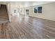 Open-concept living area featuring hard surface floors, white walls and staircase at 20028 E 62Nd Ave, Aurora, CO 80019