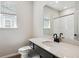Modern bathroom features a single sink vanity with a quartz countertop and black fixtures at 14135 Deertrack Ln, Parker, CO 80134