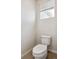 Toilet in a bright bathroom with a window and blinds, providing ample natural light at 14135 Deertrack Ln, Parker, CO 80134