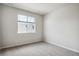 Bright, neutral bedroom with carpet and a large window at 14135 Deertrack Ln, Parker, CO 80134