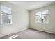 Neutral bedroom with carpet, two windows and natural light at 14135 Deertrack Ln, Parker, CO 80134