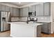 Contemporary kitchen features stainless steel appliances, gray cabinetry, modern countertops and island with sink at 14135 Deertrack Ln, Parker, CO 80134