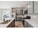 Modern kitchen showcasing stainless steel appliances, gray cabinets, island with sink, and stylish countertops at 14135 Deertrack Ln, Parker, CO 80134