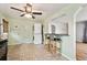 A kitchen with a breakfast bar, laundry area, neutral flooring, and light green walls at 2849 W Vassar Ave, Denver, CO 80219