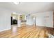 Open living room showing view to the kitchen, wood floors, neutral walls, and breakfast bar area at 2849 W Vassar Ave, Denver, CO 80219