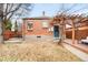 Brick home exterior features a well-maintained yard, patio with dining and a pergola with seating at 4938 W Hayward Pl, Denver, CO 80212