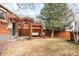 Beautiful backyard with a wooden deck, a lush lawn, and mature trees at 4938 W Hayward Pl, Denver, CO 80212