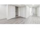 Finished basement with gray vinyl flooring, closet and open floor plan at 7952 Zuni St, Denver, CO 80221