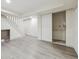 Large finished basement with gray vinyl flooring and staircase at 7952 Zuni St, Denver, CO 80221