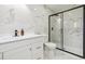 Renovated bathroom with white vanity, black framed shower, and modern finishes at 7952 Zuni St, Denver, CO 80221