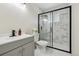 Bathroom featuring marble-look tile shower with black trim and modern vanity at 7952 Zuni St, Denver, CO 80221