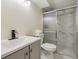Bathroom showcasing updated vanity, toilet, and a marble-tiled shower at 7952 Zuni St, Denver, CO 80221