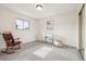 Neutral bedroom with two windows, and space for relaxing in an armchair and rocker at 7952 Zuni St, Denver, CO 80221
