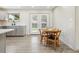 Dining area with wood table and chairs and door leading to outdoor space at 7952 Zuni St, Denver, CO 80221