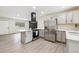 Updated kitchen features gray cabinets, stainless appliances, and a modern range hood at 7952 Zuni St, Denver, CO 80221