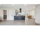 Bright kitchen featuring modern island with barstool seating, open to a dining area and living space at 7952 Zuni St, Denver, CO 80221