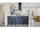 Kitchen island featuring barstool seating and modern fixtures at 7952 Zuni St, Denver, CO 80221