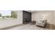 Bright living room featuring a dark brick fireplace, large window, and comfortable seating area at 7952 Zuni St, Denver, CO 80221
