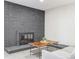 Close-up of living room with dark brick fireplace, perfect for relaxation, and cozy decor at 7952 Zuni St, Denver, CO 80221