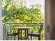 Cozy balcony features a bistro set with a tranquil view of lush greenery at 1401 Delgany St # 202, Denver, CO 80202