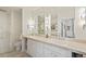 Bathroom features double sinks, tile flooring, and updated lighting fixtures at 1401 Delgany St # 202, Denver, CO 80202