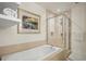 Bathroom showcasing a bathtub and a glass shower with tile surround at 1401 Delgany St # 202, Denver, CO 80202