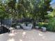 Modern courtyard with unique gray furniture, mature trees, and lush landscaping at 1401 Delgany St # 202, Denver, CO 80202