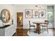 Bright dining area features a modern chandelier, seating for two, and access to a balcony at 1401 Delgany St # 202, Denver, CO 80202