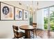 Cozy dining area with round wood table, chairs, modern light fixture, and large window at 1401 Delgany St # 202, Denver, CO 80202