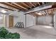 Unfinished basement provides ample storage or customization opportunities with exposed beams at 105 Hawthorn St, Frederick, CO 80530