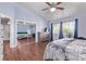 Bedroom with wood-look floors, a ceiling fan, and a mirrored closet at 105 Hawthorn St, Frederick, CO 80530