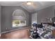 Vaulted ceiling bedroom with a large arched window and wood-look flooring at 105 Hawthorn St, Frederick, CO 80530