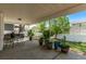 Inviting covered patio area with a charming green metal table set, perfect for outdoor dining and relaxing at 105 Hawthorn St, Frederick, CO 80530