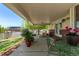 Charming covered patio with room for outdoor dining and relaxation with garden views at 105 Hawthorn St, Frederick, CO 80530