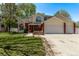 Inviting home with manicured lawn, brick details, and a three-car garage for ample parking at 105 Hawthorn St, Frederick, CO 80530