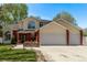 Charming home with red brick accents, three-car garage, and a well-maintained lawn and garden at 105 Hawthorn St, Frederick, CO 80530