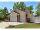 Features a spacious three-car garage with brick accents and a well-kept lawn at 105 Hawthorn St, Frederick, CO 80530