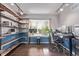Inviting home office with custom shelves, large window, and sleek desk setup, ideal for productivity at 105 Hawthorn St, Frederick, CO 80530