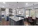 Bright kitchen with stainless appliances, an island, and an adjacent dining area, great for entertaining at 105 Hawthorn St, Frederick, CO 80530