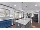 Open kitchen featuring a center island with seating, stainless steel appliances, and sleek countertops at 105 Hawthorn St, Frederick, CO 80530