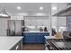 Modern kitchen with stainless steel appliances, blue lower cabinets, and white upper cabinets at 105 Hawthorn St, Frederick, CO 80530